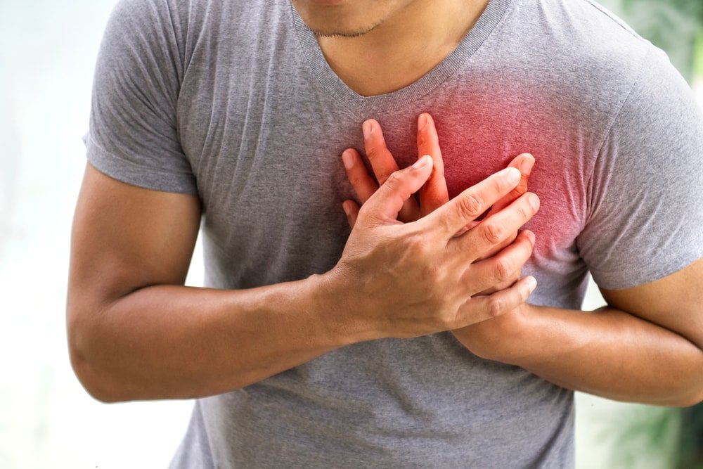 Man experiencing chest pain and breathing difficulty symptoms of lung or heart problem