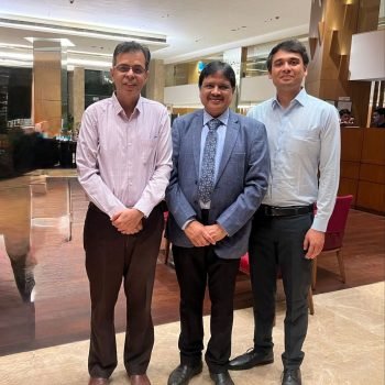 Pulmonologist with medical professionals at a healthcare conference or meeting